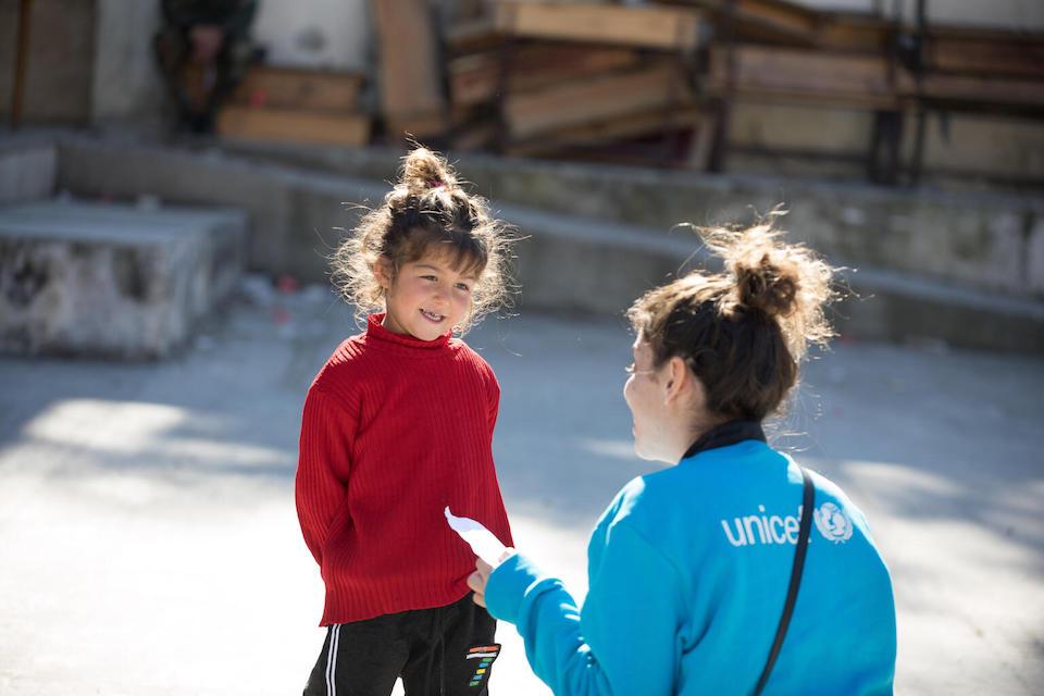 On Feb. 20, 2023, 4-year-old Naya shows her drawing to a UNICEF staff member during an art activity in a shelter for displaced families in Stamo village, Lattakia governorate, Syria.