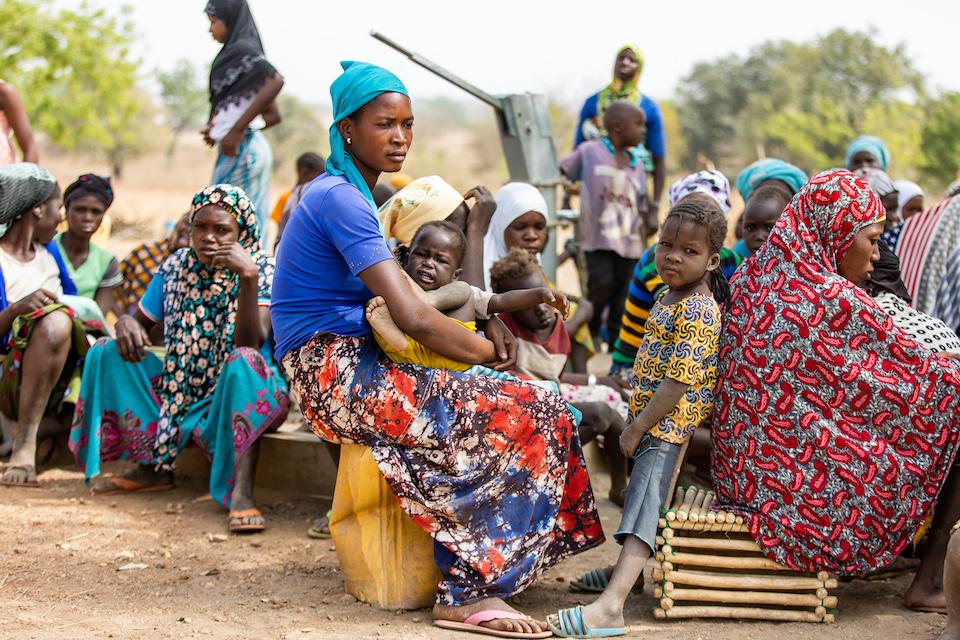 Mothers and children who fled Burkina Faso due to rising violence and insecurity settle at a camp for displaced families in Sapelliga, Ghana.