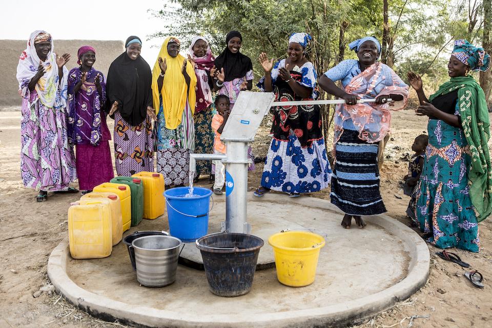 Women from Dialangou village in Mali's Mopti region gather around a new UNICEF water pump.