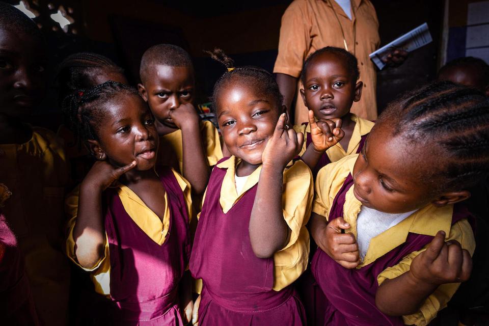 Kindergarten students in Monrovia, Liberia, proudly show their marked fingers showing they have received the oral polio vaccine.