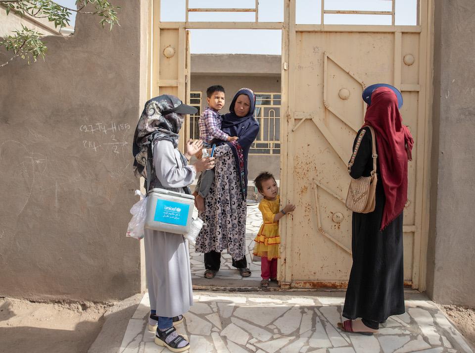 Volunteer vaccinators visit a home in Herat province, Afghanistan, as part of a UNICEF-supported national polio immunization campaign.