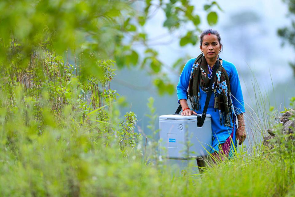 A UNICEF-supported health worker en route to a community vaccination event in Jorayal rural municipality, Doti district, west Nepal.