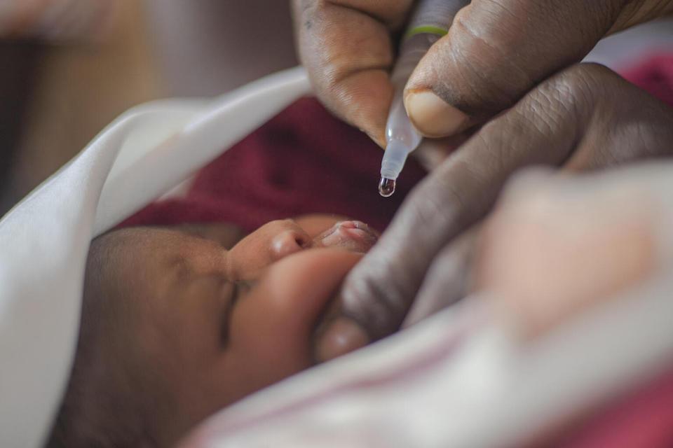 A midwife administers the polio vaccine to a baby at Ogur Health Center IV in Uganda's Lira District. 