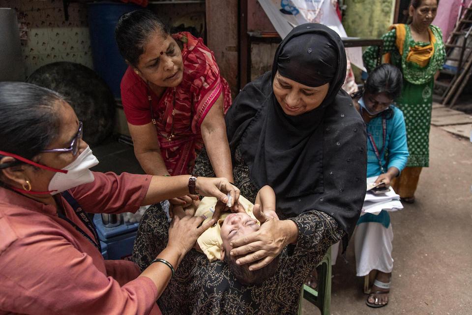 A baby is given routine vaccinations at Qureshi Nagar Health Camp in Kurla, Mumbai, India. 