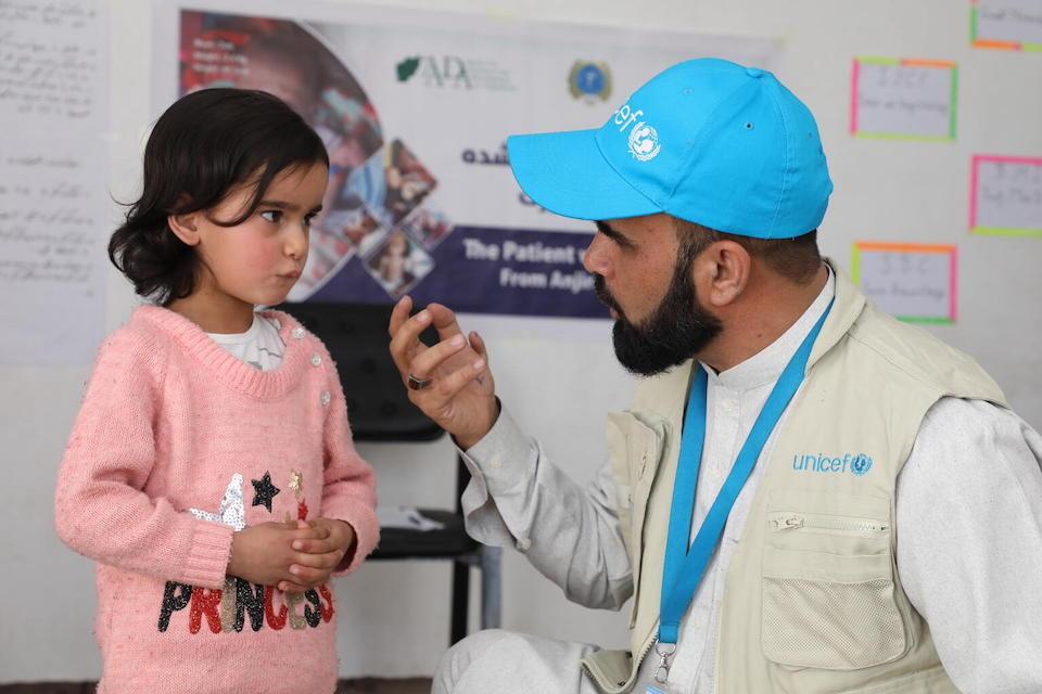Dr. Shafiqullah Safi, UNICEF Nutrition Specialist, asks 4-year-old Marjan, who recently recovered from malnutrition after being given RUTF, about her appetite