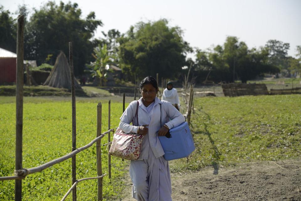 UNICEF-supported health worker Parmeswari Adhikari carries vaccines packed in cold-chain carriers to remote villages in Dhubri district, Assam state, India.