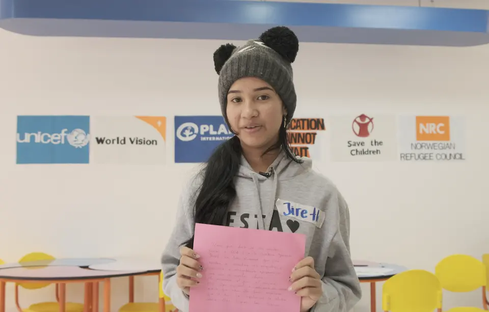 Jireth, an adolescent supported by Plan International, reads her Postcard from the Edge during ECW’s mission to Colombia.