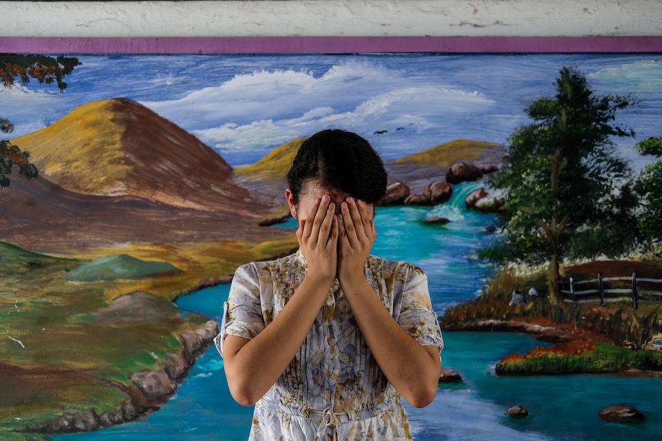 Patricia, 14, covers her face in a school in Soyapango municipality in the San Salvador, Department of El Salvador, a city widely known as one of the most notorious municipalities for gang violence in Central America.