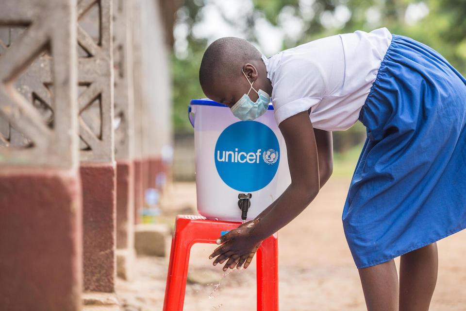 A student washes her hands before class at a UNICEF-supplied hygiene station outside Elikya I Primary School in Mbandaka, Democratic Republic of Congo. 