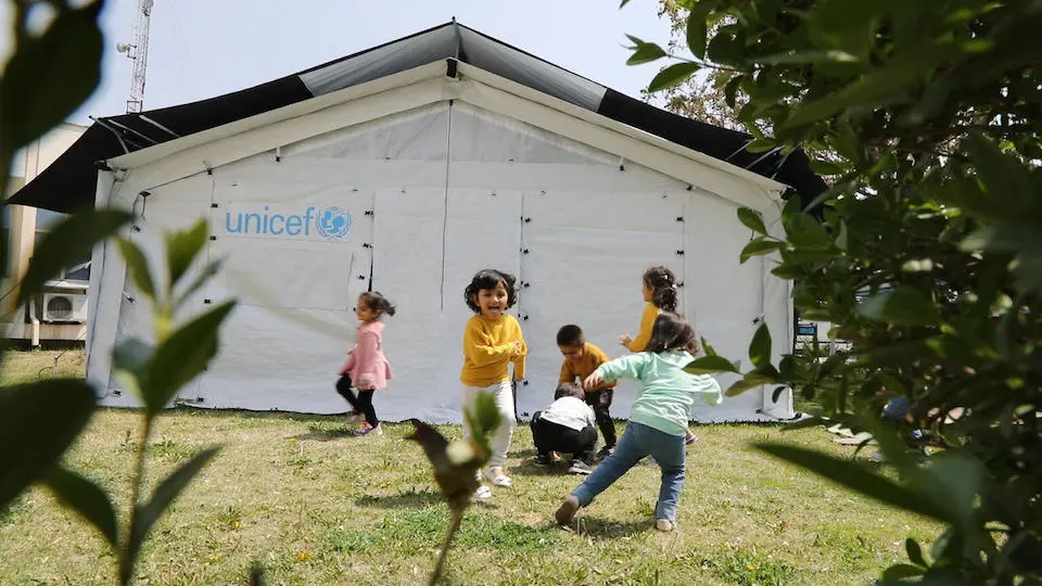 Children play inside and outside UNICEF high performance tents recently installed in Afghanistan to house community-based education programs.