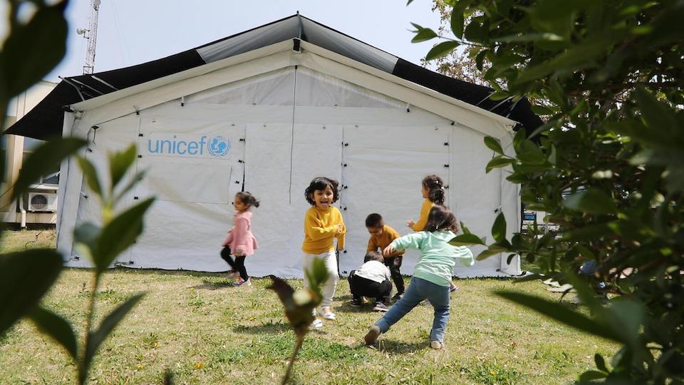 Children play inside and outside UNICEF high performance tents recently installed in Afghanistan to house community-based education programs. 