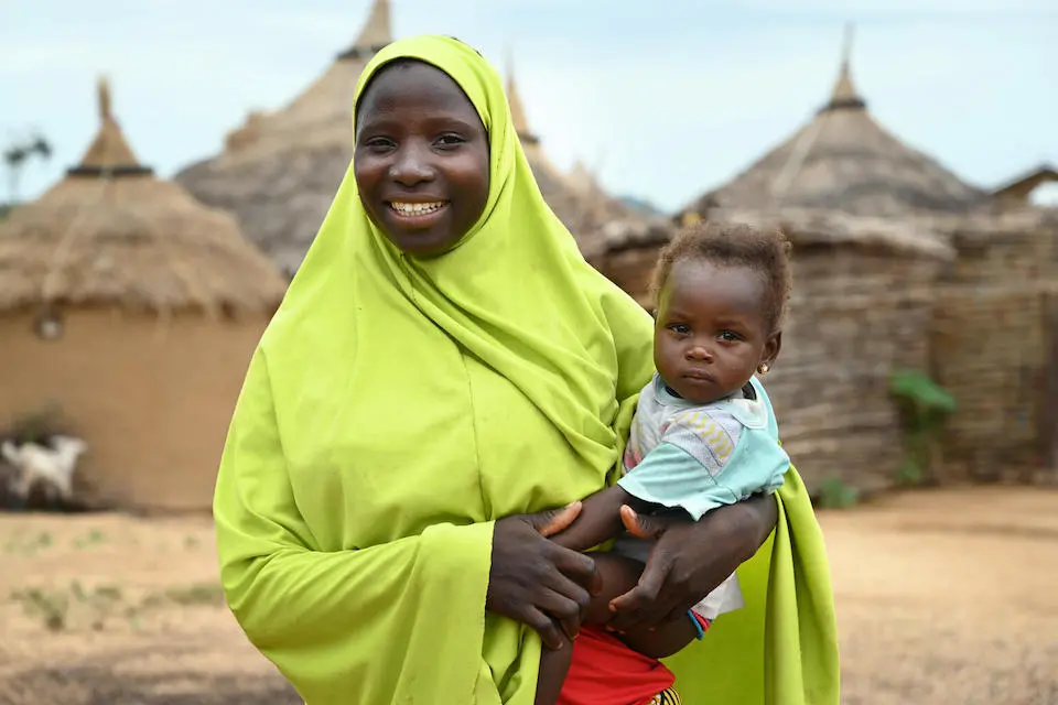 18-year-old Mamoudou of Cameroon, holding her 12-month-old daughter, recalls how she was forced to marry under threat of violence but is now able to become more independent with UNICEF support.