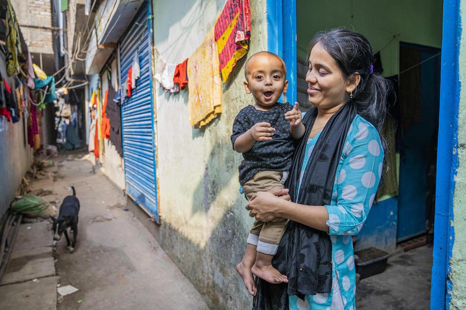 A mother holds her 16-month-old son in Karail, a poverty-stricken section of Dhaka, Bangladesh.