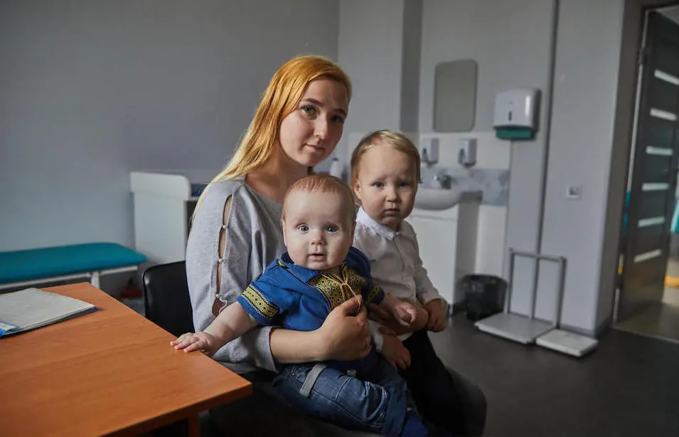 On April 20, 2023, a mother takes her children to a clinic in Kyiv for vaccination.