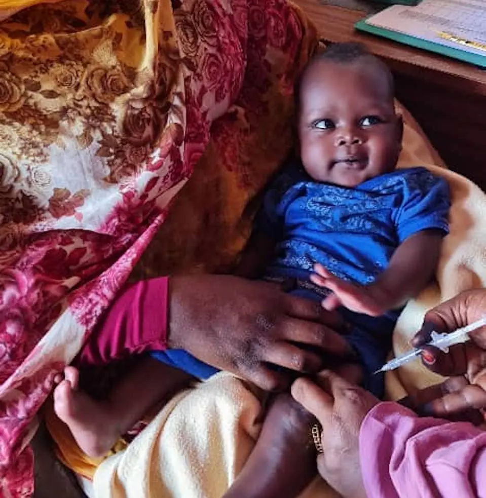 In Sudan, a 3-month-old child is immunized at Kenana health center, a UNICEF-supported facility.