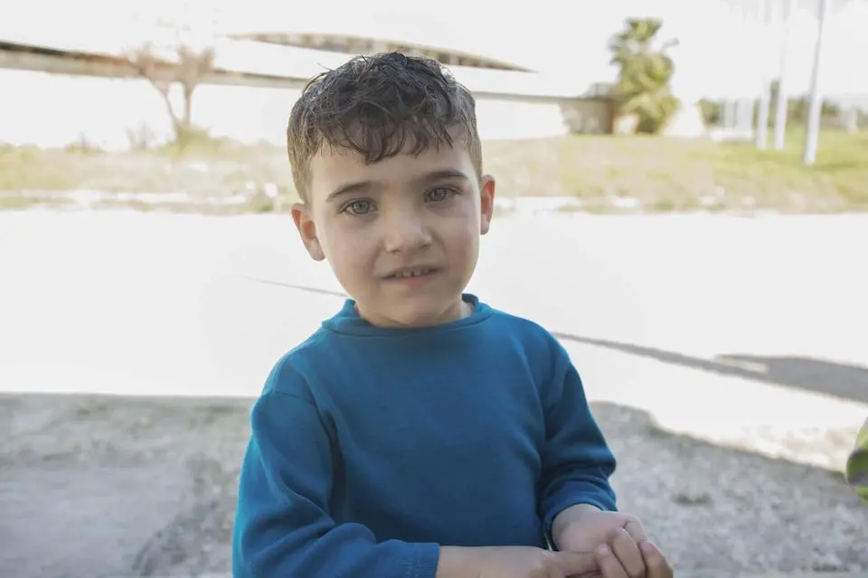 Ibrahim and his family use prefab bathrooms installed by UNICEF at the sports city collective shelter in Lattakia, Syria, after the 2022 earthquakes.