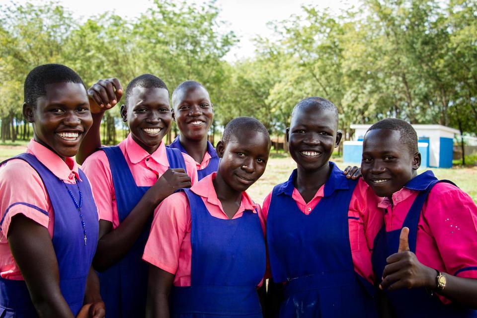 Female students pose in front of the new UNICEF funded bathrooms at Umwia Primary School in Adjumani District, Northern Uganda.