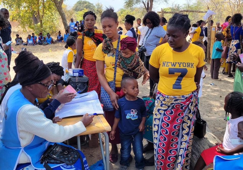 Mothers with children attend to a community event focused on health and nutrition in rural Zambia supported by UNICEF.