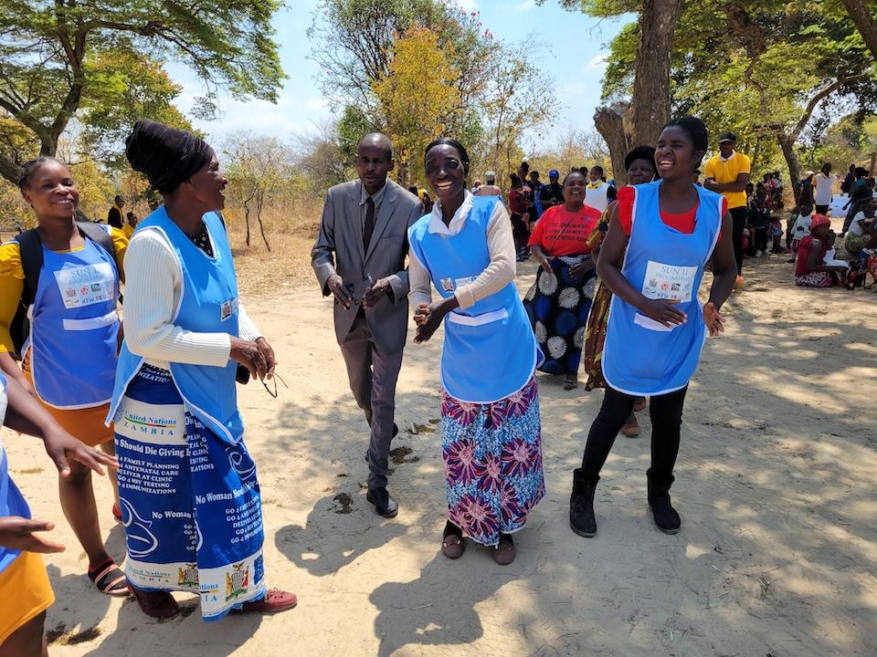 Volunteers with a UNICEF-supported nutrition program in rural Zambia greet visits with enthusiasm.