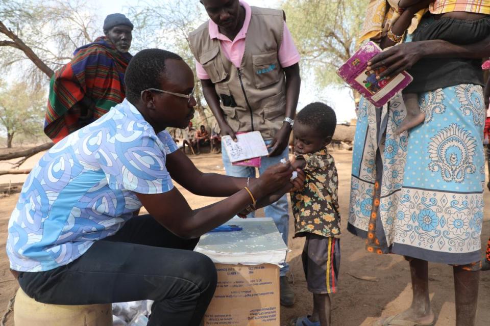 Francis Chemino Eloiloi immunizes 5-year-old Akenson during a UNICEF-supported measles vaccination campaign in Kangataruk Village, northern Kenya