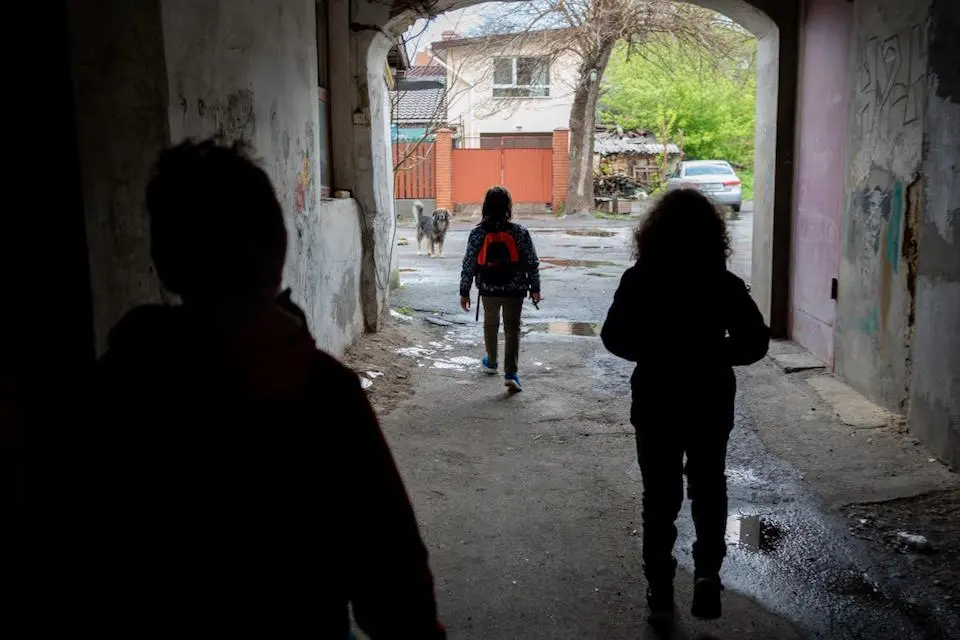 Brothers 10-year-old Yehor, 8-year-old Hlib and 11-year-old Tymofiy in the yard of their home in Kherson, Ukraine.