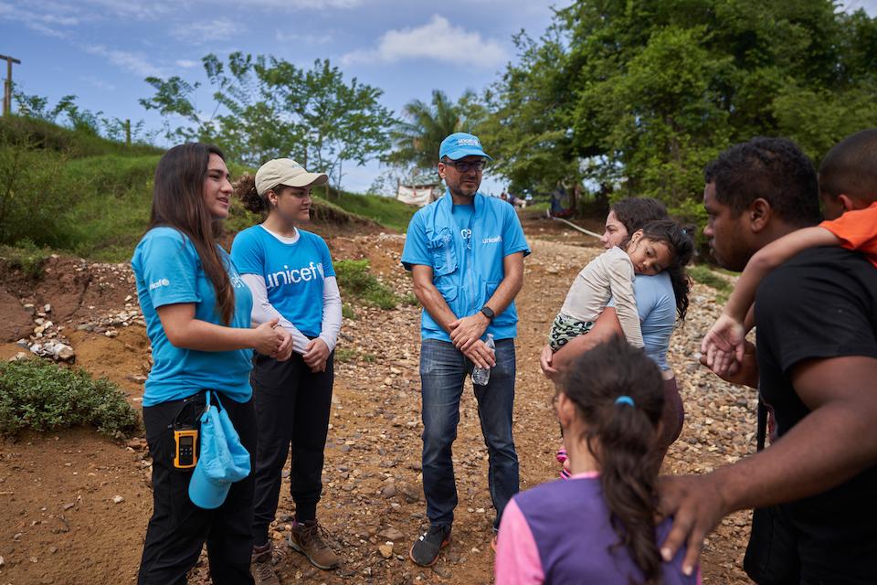 UNICEF USA Ambassador Laurie Hernandez speaks with a migrant family who has just arrived by canoe at the TMRS in Lajas Blancas, Darién province, Panama, May 2023.
