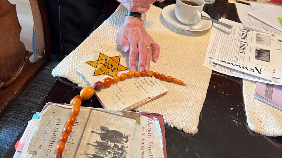 Holocaust survivor Margot Friedlaender with her mother's necklace and address book, and the Jewish Star she was forced to wear in Nazi Germany.