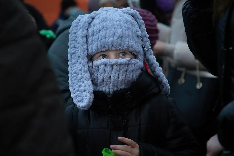 A child waits for her mother in the passport line at border control in Isaccea, Romania on March 4, 2022.