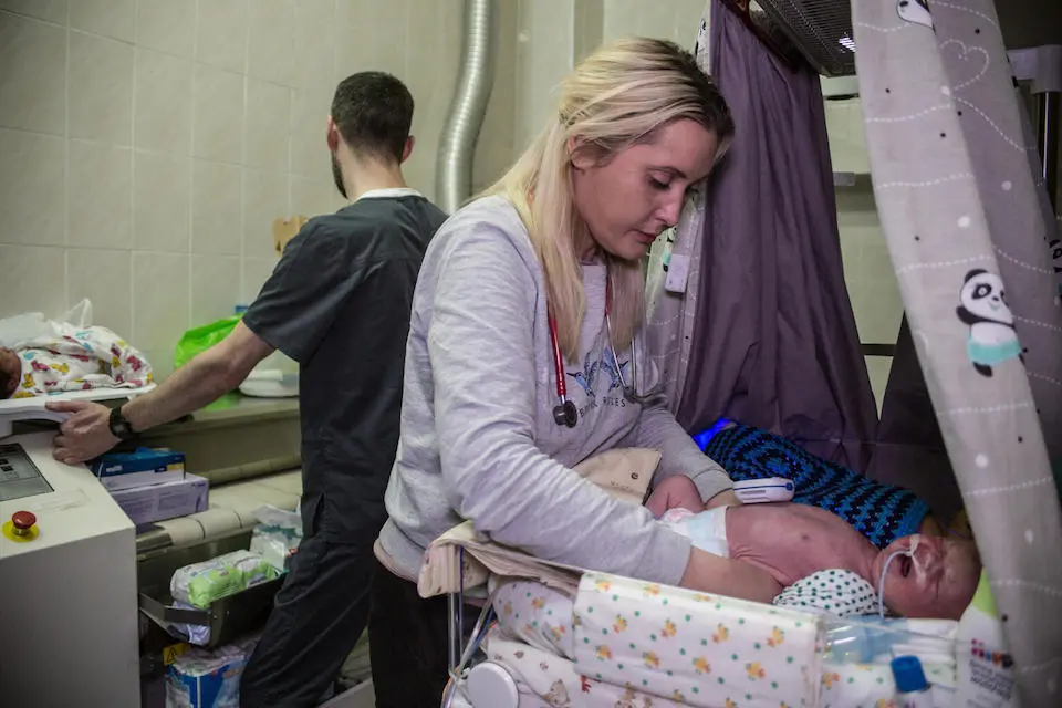 At the Kyiv Regional Perinatal Center in Ukraine, Nellia Izmailovna, Chief of the Children's Intensive Care Unit, cares for a child on March 7. The center's basement has been turned into a makeshift maternity ward.