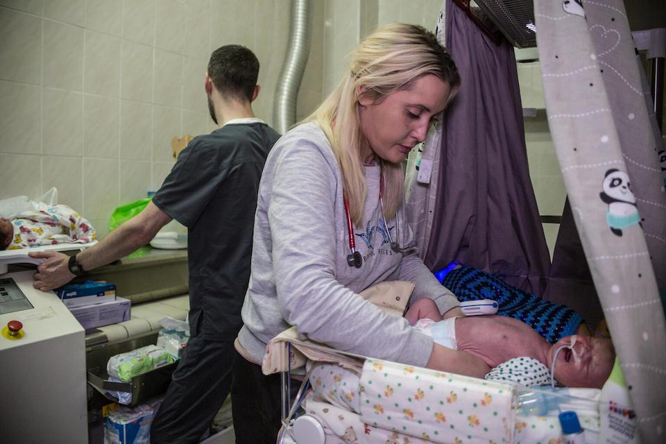 At the Kyiv Regional Perinatal Center in Ukraine, Nellia Izmailovna, Chief of the Children's Intensive Care Unit, cares for a child on March 7. The center's basement has been turned into a makeshift maternity ward. 