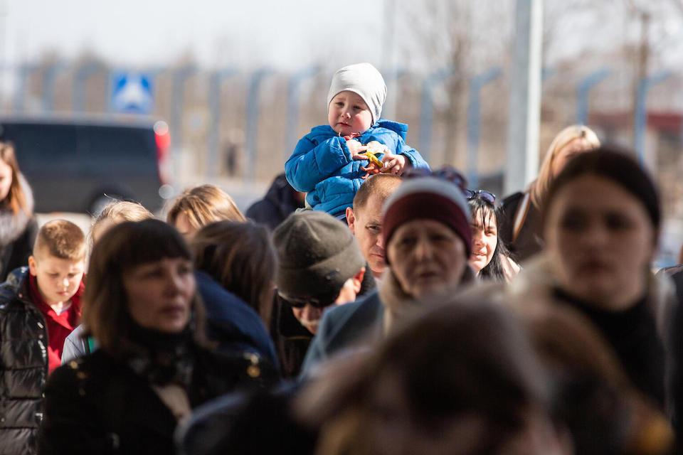 Refugees stand in line at the border crossing between Ukraine and Moldova at Palanca on March 24, 2022.