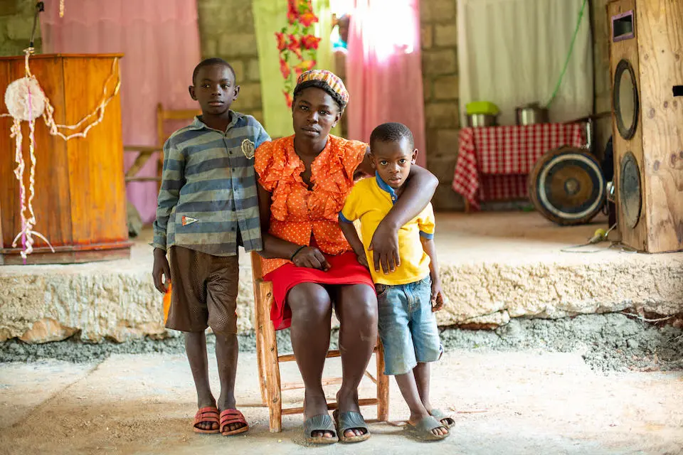 Rosemilande Themislocle and her two children are benefiting from UNICEF's emergency water program in Kafou Zaboka, Jeremie, Haiti.
