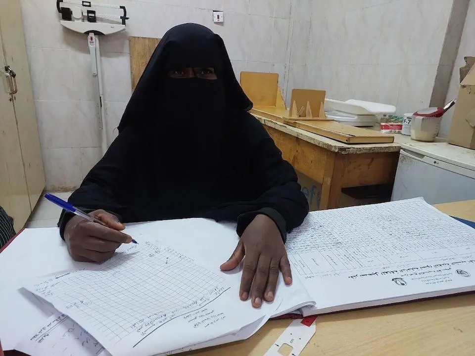 Nutritionist Nour-elhuda Abdallah Salih updates assessment records at Dongola, a UNICEF-supported hospital and malnutrition treatment center in Northern State, Sudan.