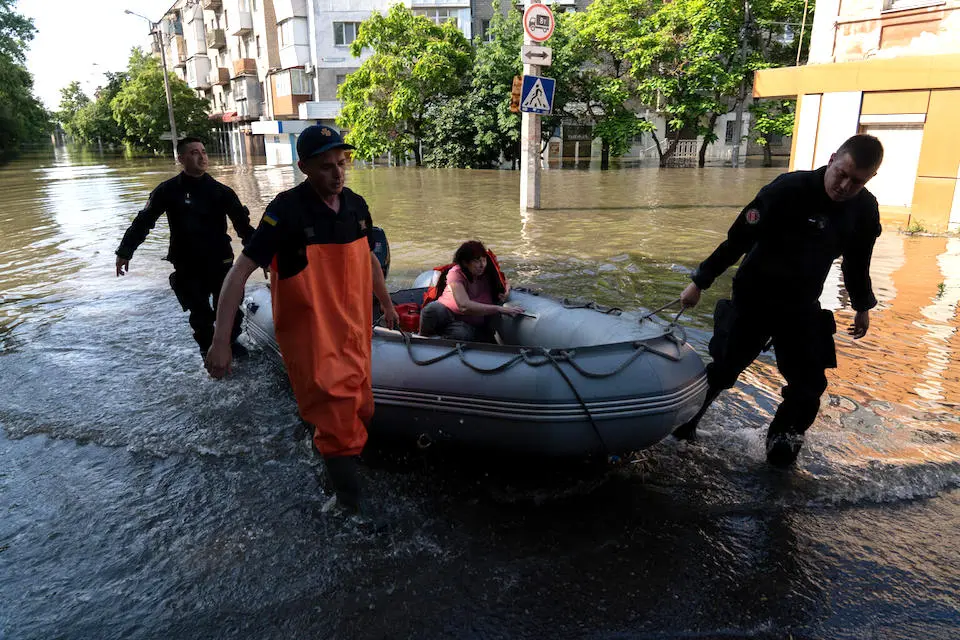 Local residents are rescued following the June 6 collapse of the Kakhovka hydroelectric dam in southern Ukraine.