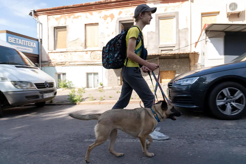 Mykyta, a 14-year-old boy from Kherson, had to climb through his second floor window to enter a rescue boat.