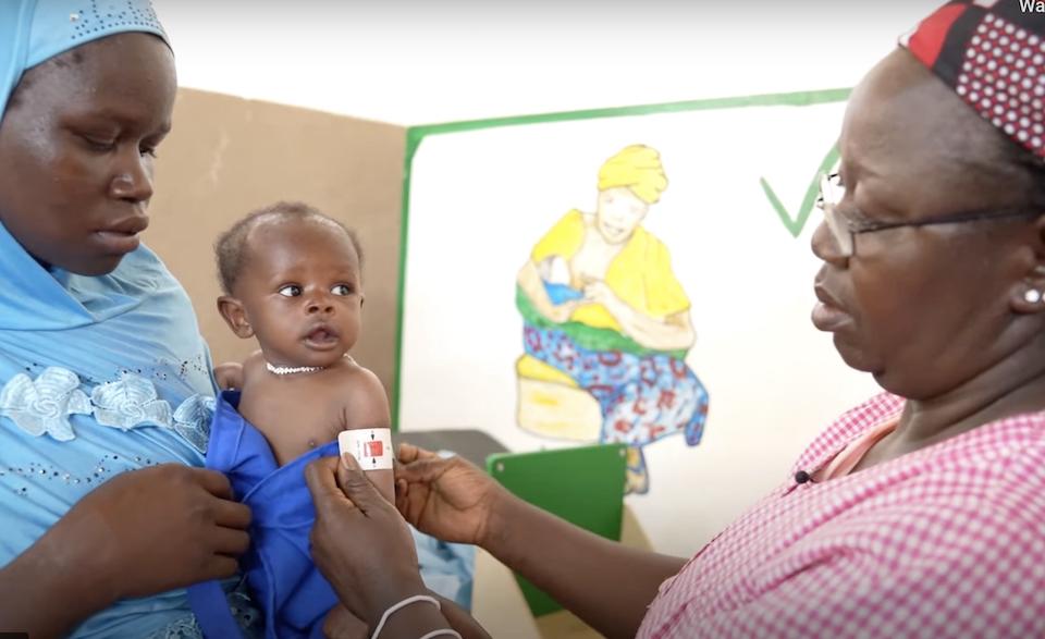 A nurse measures a child's middle upper arm circumference to screen for malnutrition at UNICEF-supported hospital in Kaya district, north-central Burkina Faso.