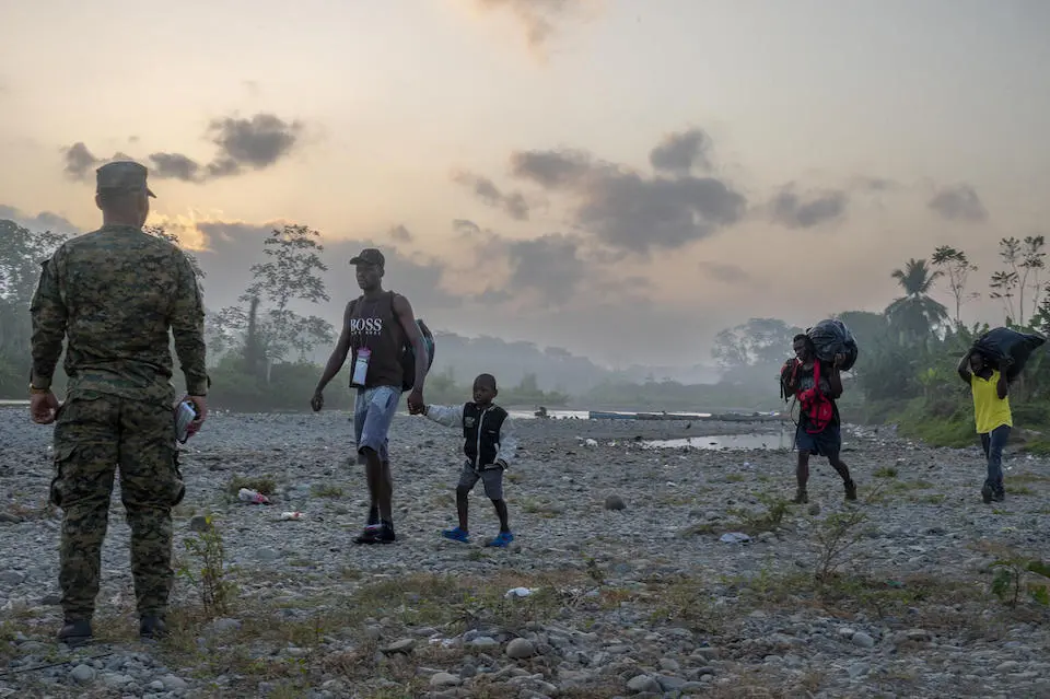 At the Bajo Chiquito Migrant Reception Station in Panama in February, 2023, migrant families line up to board the canoes that will take them to the second immigration station in Lajas Blancas.