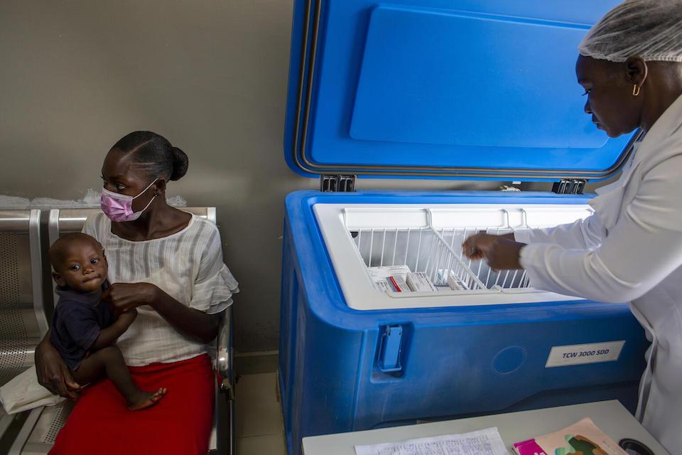 Head Nurse Nsingui Pedro Cardosa inspects vaccines in the cold storage facility at Benfica Maternal and Child Health Center in Angola