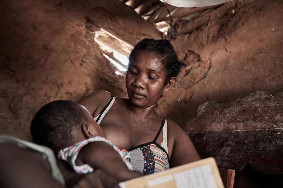 On March 17, 2023, in Madagascar's Atsimo Andrefana region, – Georgine breastfeeds her daughter Victorine in their home, which was damaged by Hurricane Freddy.