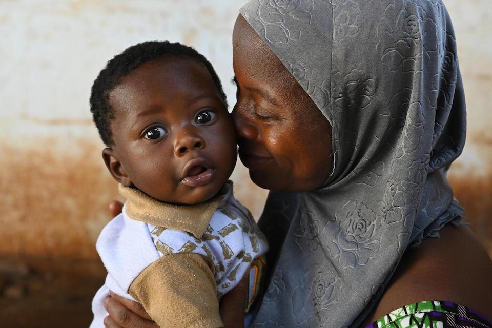 A mother, holding her young child, at a UNICEF-supported health center in Fada, east Burkina Faso.