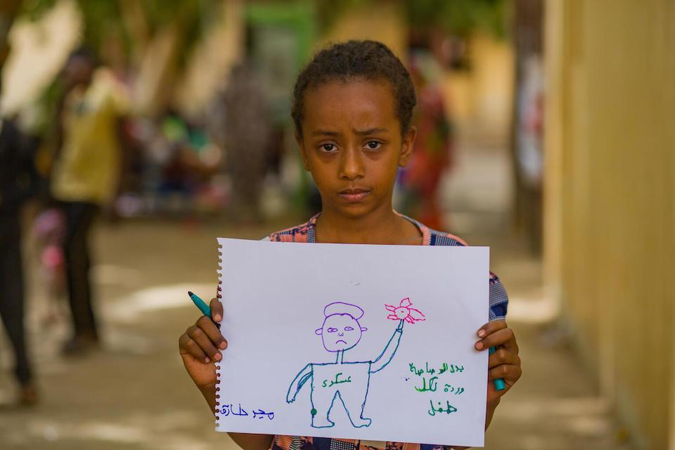 On June 3, 2023 at a center for families displaced by conflict in Sudan, Majd drew a soldier with a flower stuffed in the muzzle of his gun. 
