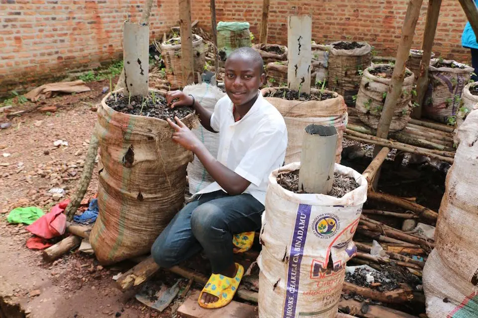 Don Précieux, 14, shows vegetables he and classmates grew at Kabari Basic School in Ngozi Province, Burundi.