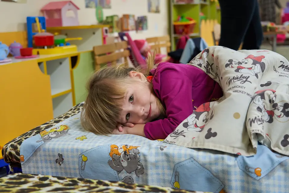 In Slavutych, Ukraine, children nap, play and learn in a basement bomb shelter built by UNICEF.