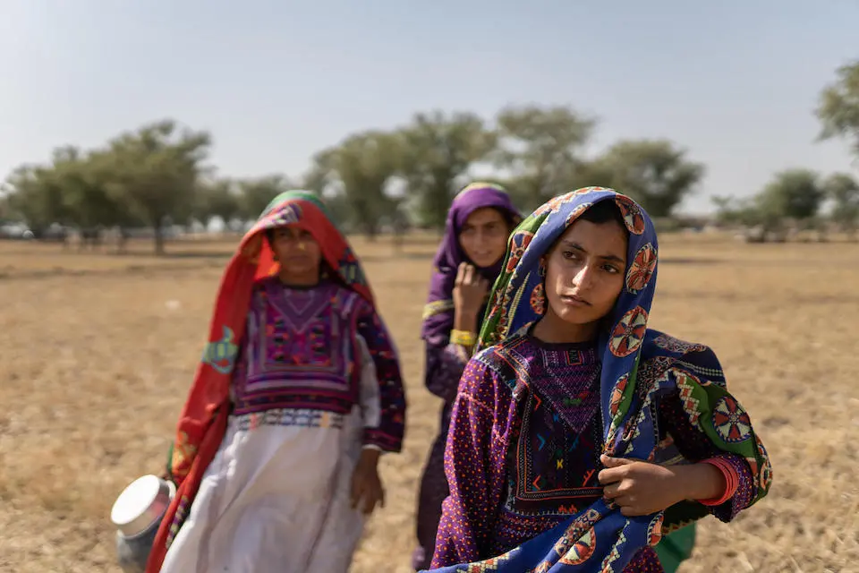 A mother and her two daughters on their way to fetch water from a pond 45 minutes away from home in Allah Abad, Jampur, South Punjab, Pakistan.