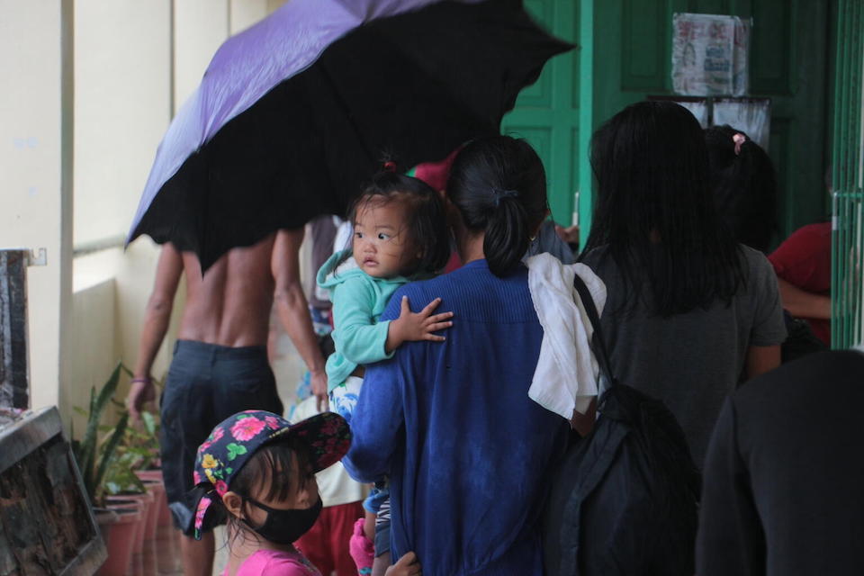 A mother and child find shelter with other displaced families at Albay Central School in Legazpi City, Albay Province, the Philippines, as typhoon Vamco (Ulysses) makes landfall.