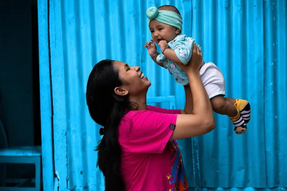 Enciani Radja holds 4-month-old Fayra after her daughter received the polio vaccine at a clinic in East Nusa Tenggara Province, Indonesia.