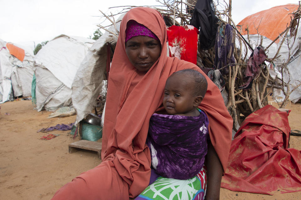 Khadijo Mohamed Aden sits with her 2-year-old daughter Sabirin outside their makeshift house in the Gurman camp for internally displaced persons on the outskirts of Mogadishu, Somalia.