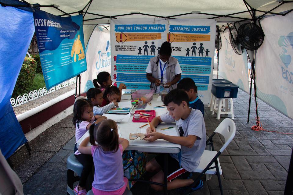 Migrant children draw, color and play games at a UNICEF-supported mobile clinic that provides health, nutrition and psychosocial support services in Parque Bicentenario in Tapachula, Chiapas, Mexico.
