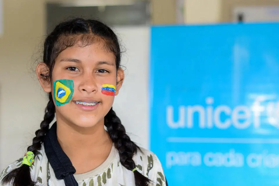 Yoannelin, 15, paints the flags of Brazil and Venezuela on her face to show her love for both countries.