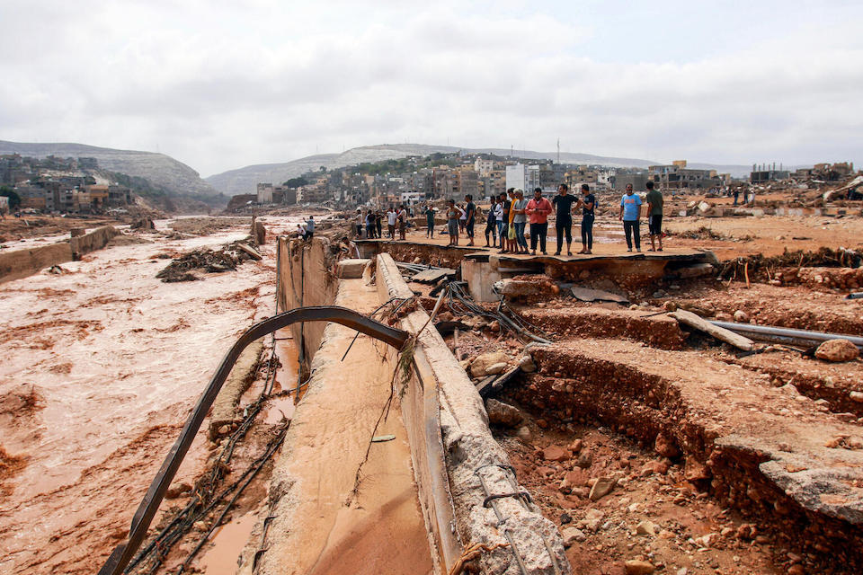 People survey damage caused by floods in Derna, eastern Libya, on Sept. 11, 2023.